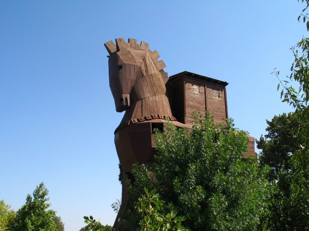 wooden horse of troy is behind the trees in daylight. One of the Ancient Heritage of Turkey.