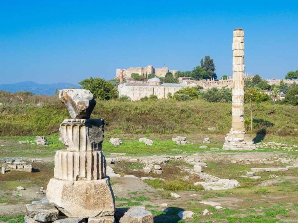 Ruins of the Temple of Artemis with Selçuk Castle in background, ending the 10 days in Turkiye itinerary.