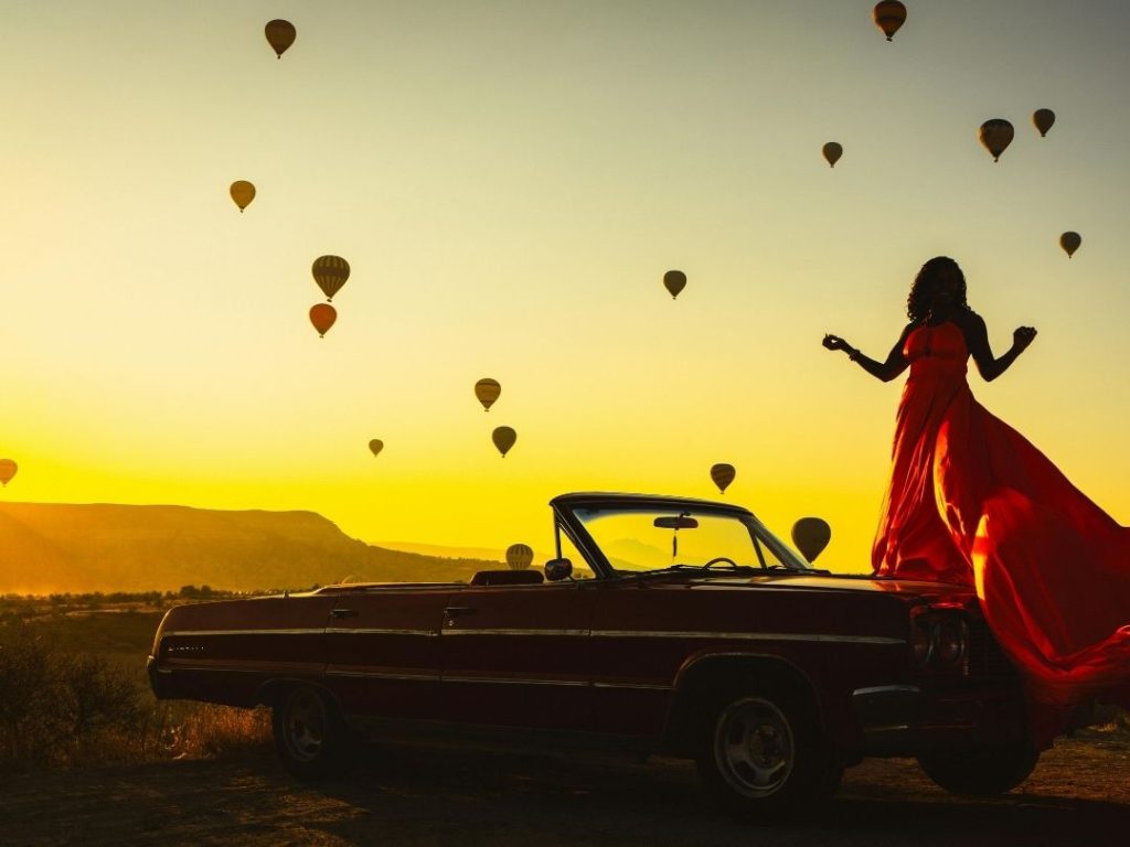 Sunrise photoshoot with hot air balloons and classic car in Cappadocia Vineyard Route, essential stop on 10 days in Turkiye itinerary.